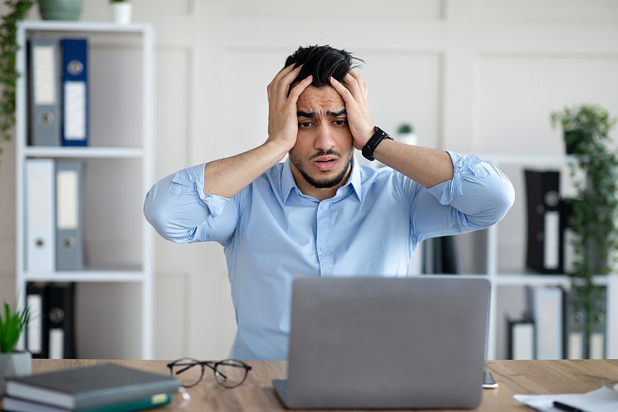 Desperate businessman having too much work, making mistake, cannot meet deadline, suffering from headache at work