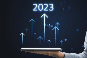 person holding mobile device in palm with overlay of upwards arrows point to 2023 to show year-end close
