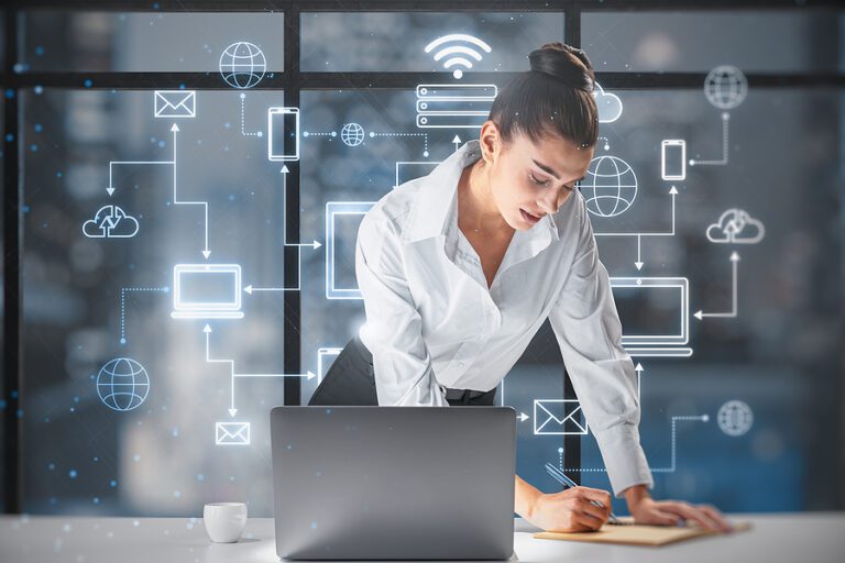 businesswoman leaning on and writing at desktop with creative glowing computer cloud network hologram on blurry office with city view background. Business and technology concept. Smart office. AI.