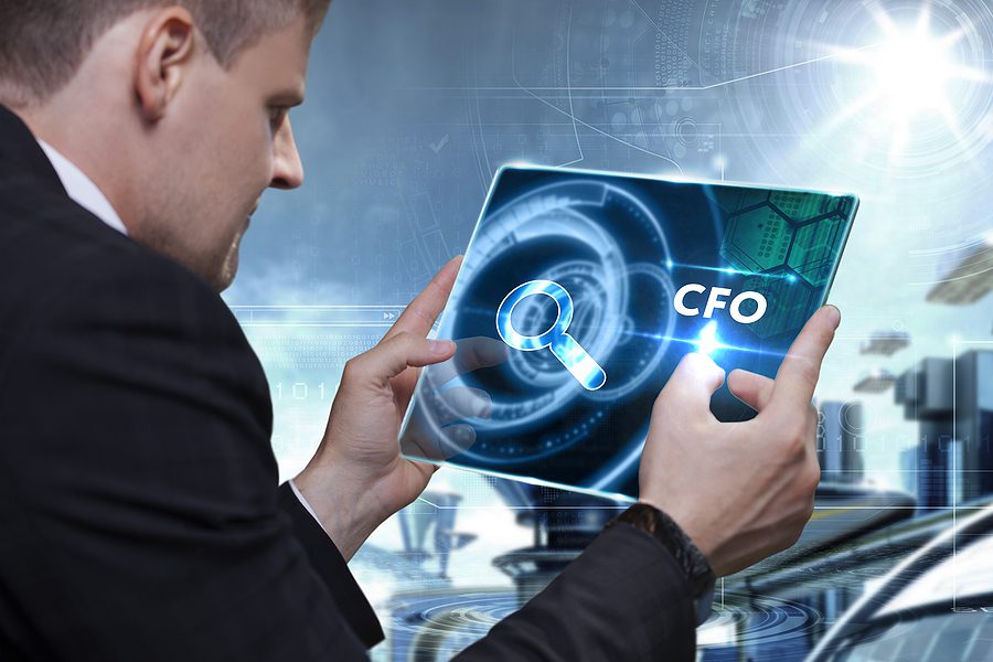 Business Technology Internet and network concept. Businessman working on the tablet of the future select on the virtual display: CFO, Finance and Accounting